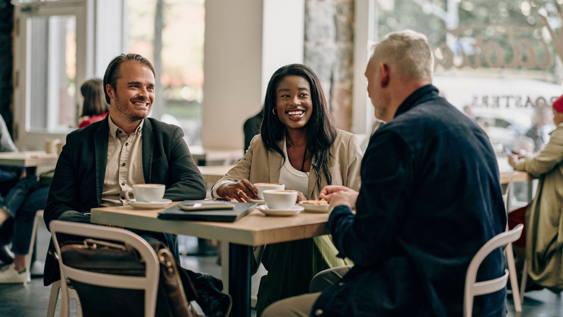 Stock image of people speaking at a coffee shop in Ottawa.