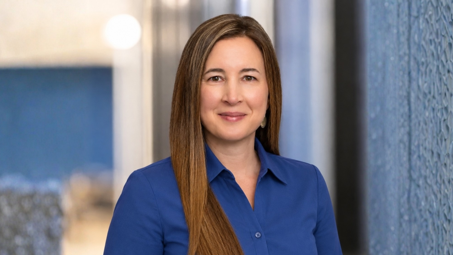 Heidi Hauver headshot from Ranovus. She wears a blue collared shirt and smiles for the camera.